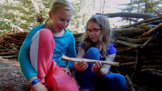 Sarah and Emily examine a kangaroo bone found in the Pialligo Redwood Forest fort.