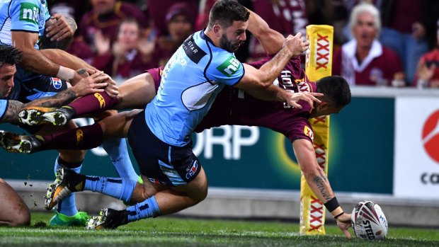 Finger-tip control: Valentine Holmes scores a stunning try in Origin III.