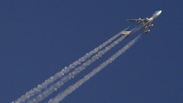 An aircraft flies high above Heathrow airport in west London ... a technical problem at the air traffic control centre in Swanwick, southern England, has forced authorities to restrict the airspace above three of London's busiest airports.