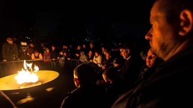 Crowds gather around the eternal flame at last year's dawn service in Melbourne.