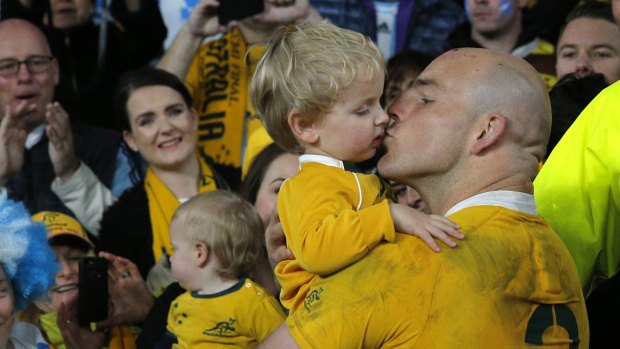 Proud dad: Australian captain Stephen Moore kisses his son Theodore after his team's 29-15 win over Argentina in their Rugby World Cup semi-final at Twickenham.