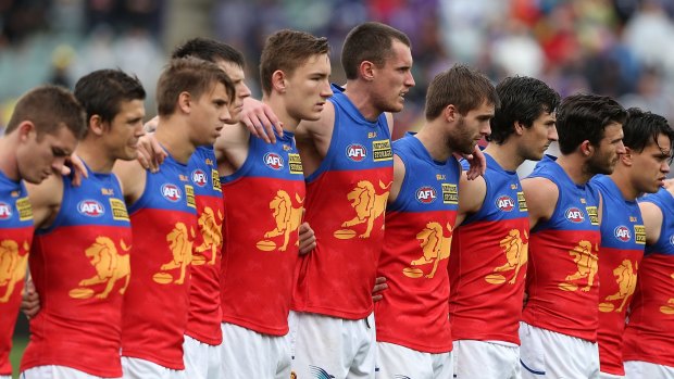 Lions players line up for a moments silence to pay respect for murdered Adelaide Crows coach Phil Walsh.