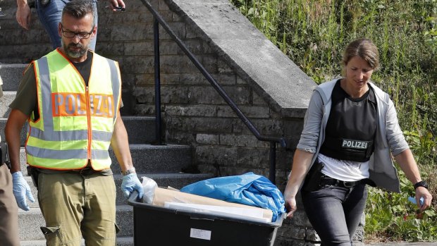 Police officers leave a former hotel where the Syrian man lived before the explosion in Ansbach.