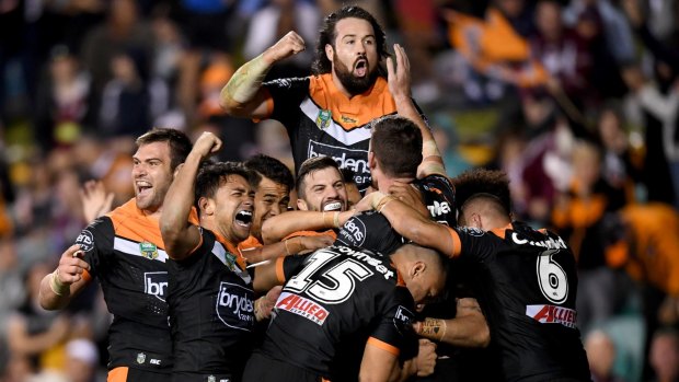 Party time: Wests Tigers players celebrate after the final try of the game.