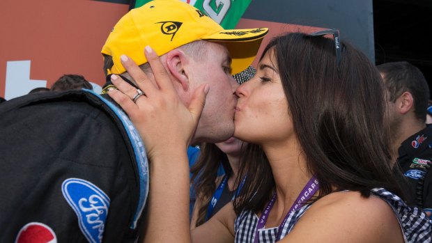 Mark Winterbottom is kissed by his wife Renee after he  clinched the 2015 V8 Supercars Championship.