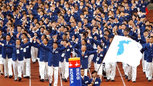 Athletes from North and South Korea march together, under a unification flag at the 14th Asian Games in Busan, South Korea in 2002.