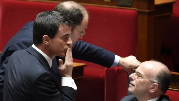 Kissing privacy goodbye: French Prime Minister Manuel Valls (left) gestures as French Interior minister Bernard Cazeneuve looks on.