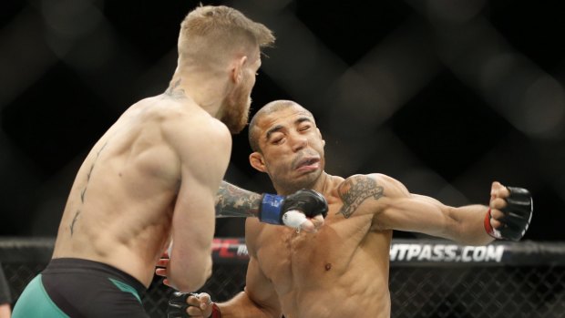 McGregor sends Jose Aldo to the floor in December 2015.