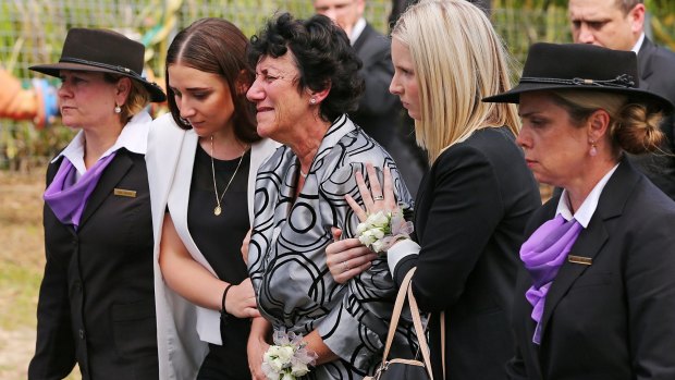 Phillip Hughes' mother, Virginia Hughes, centre, with daughter Megan Hughes, left, at the funeral.