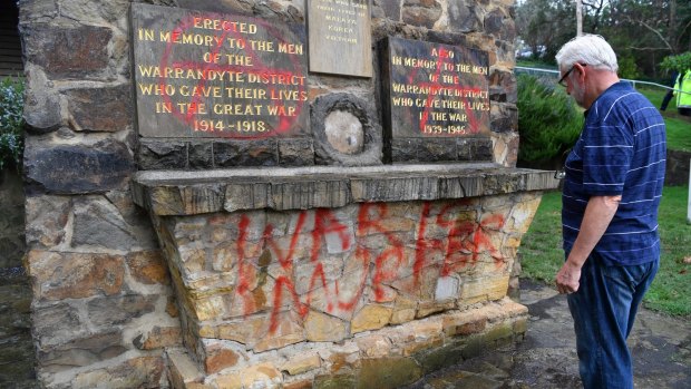 Henk Vander Helm, Warrandyte RSL president inspects anti-war graffiti sprayed on the war memorial.