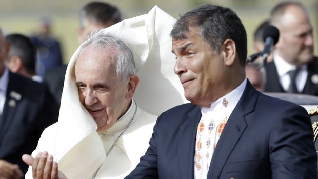 Ecuador's President Rafael, right, Correa greets Pope Francis on his arrival in Ecuador.