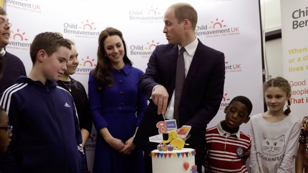 Prince William, Duke of Cambridge and Catherine, Duchess of Cambridge prepare to cut a cake to celebrate the one year anniversary of this charity's branch, during his visit to a Child Bereavement UK Centre in Stratford on January 11, 2017 in London, England. 