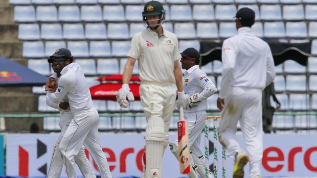 Australian batsman Adam Voges, centre, leaves the field as hosts celebrate his dismissal during day two of the first Test in Pallekele, Sri Lanka.