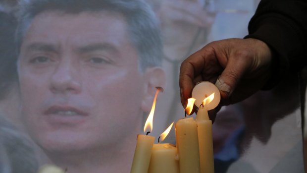 Russians light candles in memory of opposition figure Boris Nemtsov.