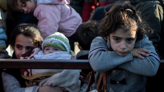 A young girl waiting in line on Monday  to pass through a border gate as a small number of Syrian refugees were allowed to return to Syria in Kilis, Turkey. 