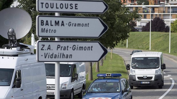 French gendarmes escort a van (right) transporting the debris found on Reunion Island to a military-run office for analysis.