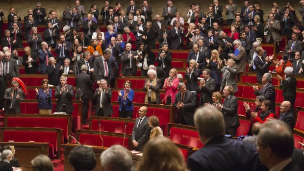 International pressure: French MPs applaud after a vote in favour of the recognition of a Palestinian state on Tuesday.