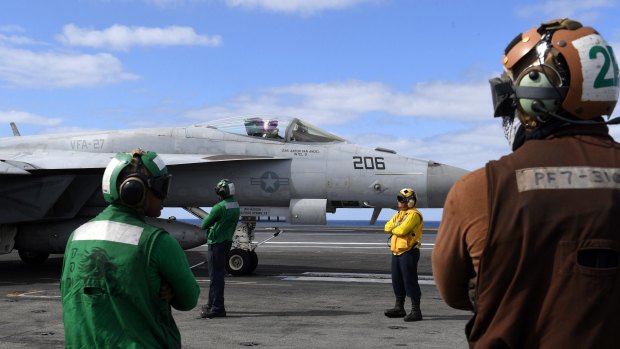 An F/A-18 Super Hornet waits to take off from  the USS Ronald Reagan in the Coral Sea, 650 klm's off the coast from Brisbane, Australia. The large aircraft carrier will dock in Brisbane on Sunday. 