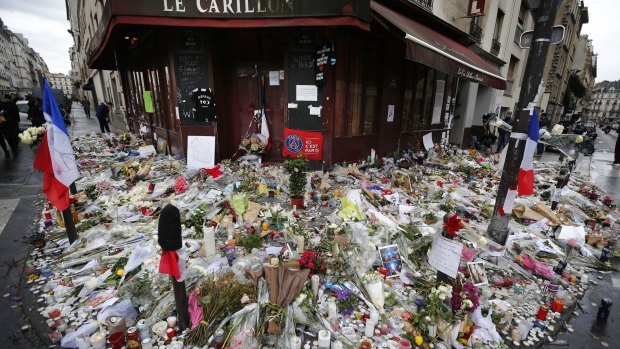Flowers and candle tributes outside the Restaurant Le Carillon in Paris, after the November 13 attacks.