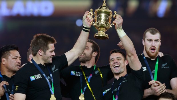 All Blacks legend: Dan Carter (right) holds the World Cup trophy aloft in 2015.