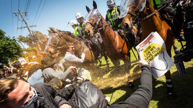 Members of the group No Room For Racism clash with police during the rally in Melton.