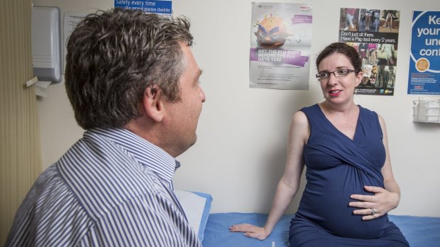Eleonor Pritchard, who is in her final trimester of pregnancy, has a consultation with Dr Martin Liedvogel following the ACT government announcement of free whooping cough shots for pregnant women.