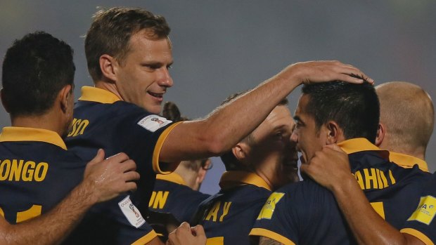 Australia's Tim Cahill (right) celebrates with teammates after scoring against Bangladesh.