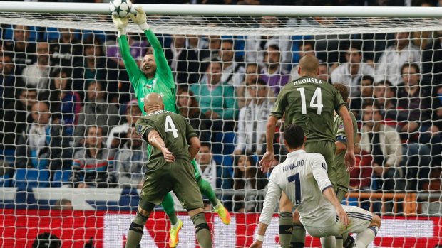 Legia goalkeeper Arkadiusz Malarz gets gloves on a shot by Real Madrid's Cristiano Ronaldo.