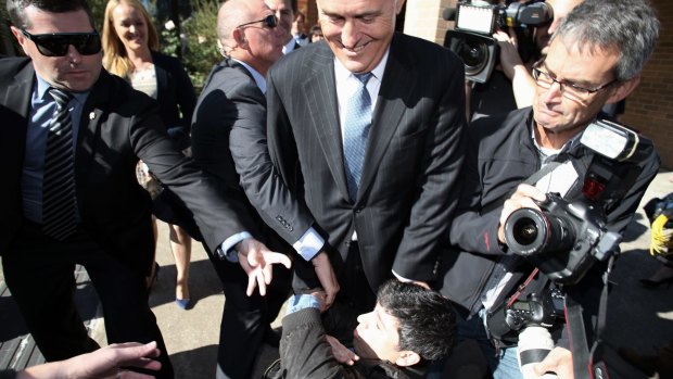 Chas Licciardello falls at the feet of Mr Turnbull.