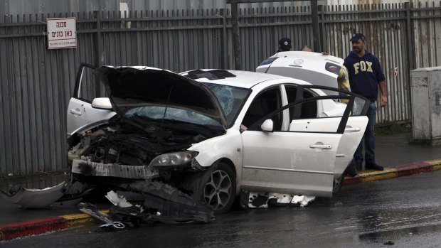 Israeli police examine a car used in a vehicular attack in Jerusalem on Monday.