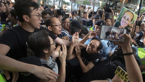 Pro-democracy protesters clash with pro-China counter-protesters blocking their march to the venue where official ceremonies were held to mark the 20th anniversary of Chinese rule over Hong Kong in Hong Kong on Saturday