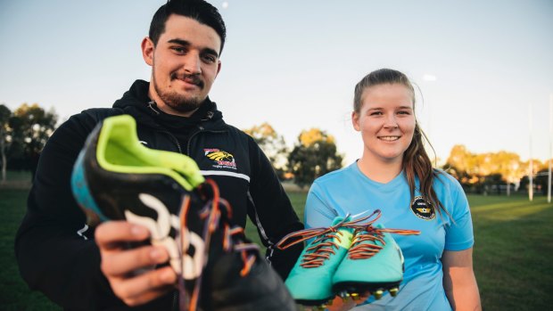 Gungahlin United's Sophie Rolfe and Gungahlin Eagles' Trent Pollard with their boots and rainbow laces ahead of this weekend's LGBTI round.