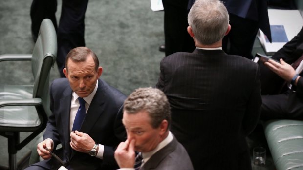 Malcolm Turnbull passes Prime Minister Tony Abbott and Christopher Pyne on Wednesday.