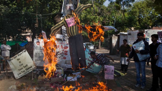 Activists hang and burn an effigy of Mukesh Singh, one among the four men convicted and sentenced to death for the 2012 rape and murder of a woman in a moving bus