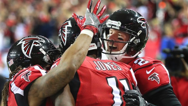 Brothers in arms: Atlanta Falcons quarterback Matt Ryan (right) and running back Devonta Freeman (left) celebrate with Julio Jones during the championship game.