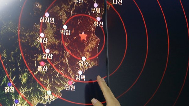 An official at Seoul's Earthquake and Volcano Monitoring Division points at the epicentre of seismic waves in North Korea.