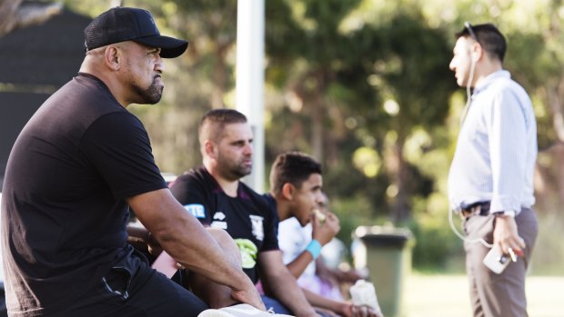 Sidelined: John Hopoate watches from the sidelines as Manly's SG Ball team trains on Tuesday.