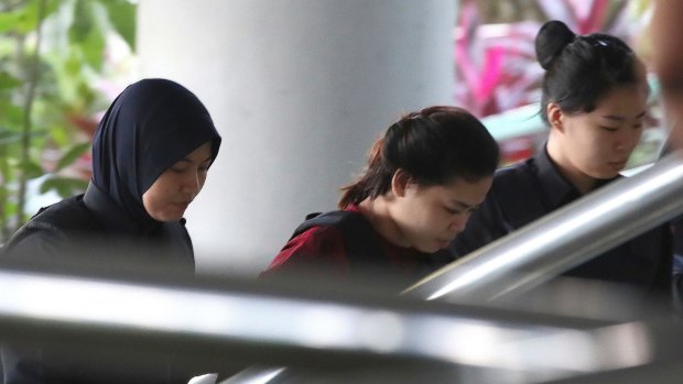 Indonesian Siti Aisyah, centre, is escorted by police as she arrives for a hearing at Shah Alam court house.