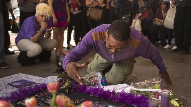 A fan cries at a makeshift memorial created in remembrance of singer Prince outside Apollo Theatre in New York on April 22, 2016.