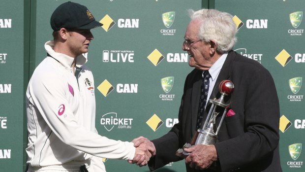 Spoils of victory: Australia captain Steve Smith shakes hands with cricket great Alan Davidson as he is presented with the Frank Worrell Trophy.