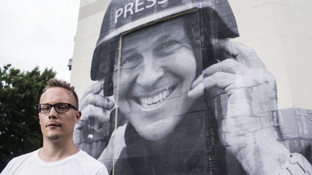 Free speech: Street artist Hego in front of his Peter Greste mural.