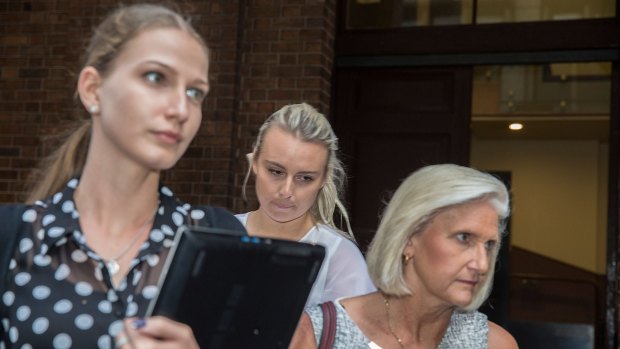 Glen McNamara's daughter Jessica, centre, leaves the NSW Supreme Court.