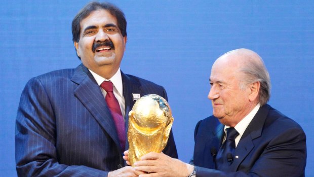 Sheikh Hamad bin Khalifa Al-Thani, Emir of Qataris presented with the World Cup trophy by former FIFA president Sepp Blatter after being awarded hosting rights for the 2022 tournament.