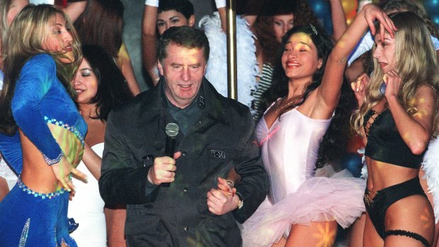 Vladimir Zhirinovsky dances with showgirls as he sings at the launch of a CD of him singing in 1999. 