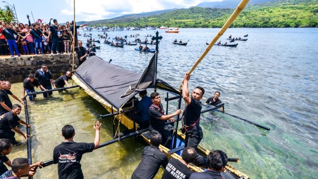 Tuan Meninu chapel congregation starting the sea procession during Semana Santa celebration in Larantuka, Indonesia. 