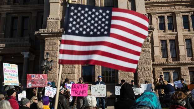 Demonstrators gather outside of the Texas Capitol in Austin in hopes of persuading more than three dozen Republican electors to cast their ballot for someone other than President-elect Donald Trump.