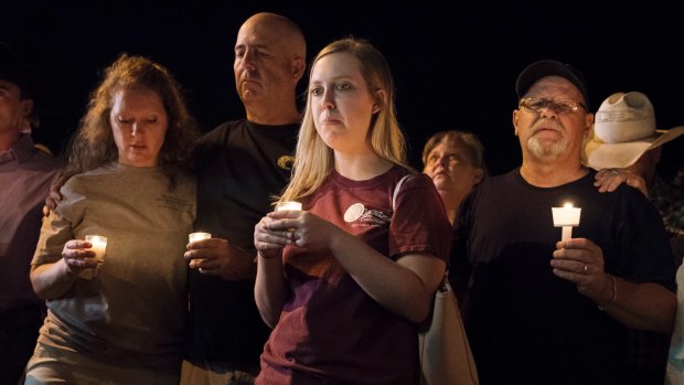 Mourners participate in a candlelight vigil held for the victims the shooting