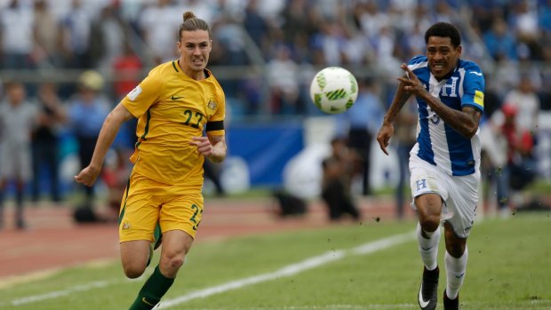 One final push: Jackson Irvine, fights for the ball with Honduras' Henry Figueroa.
