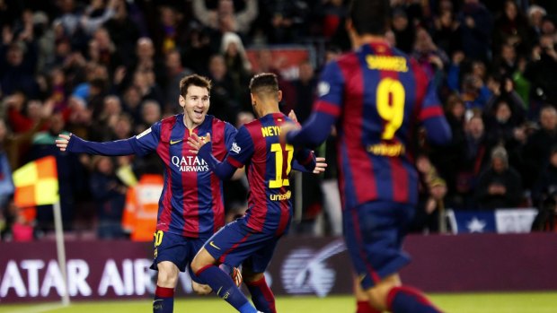 Lionel Messi celebrates with Neymar and Luis Suarez.
