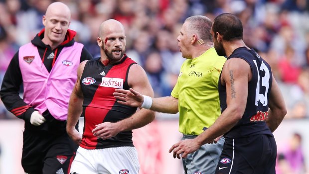 The umpire intervenes in  a confrontation between Paul Chapman and Chris Yarran.